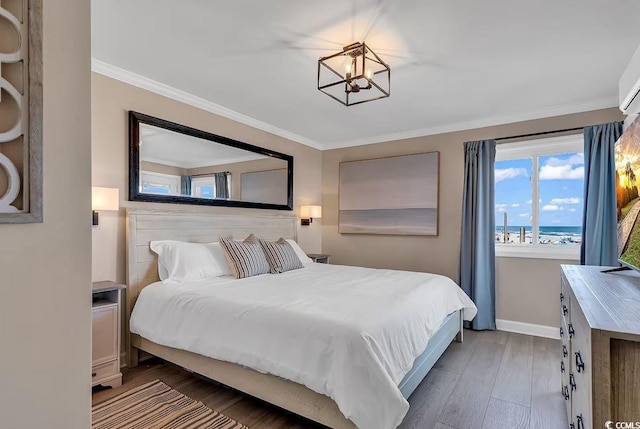 bedroom with dark hardwood / wood-style flooring, ornamental molding, and a chandelier