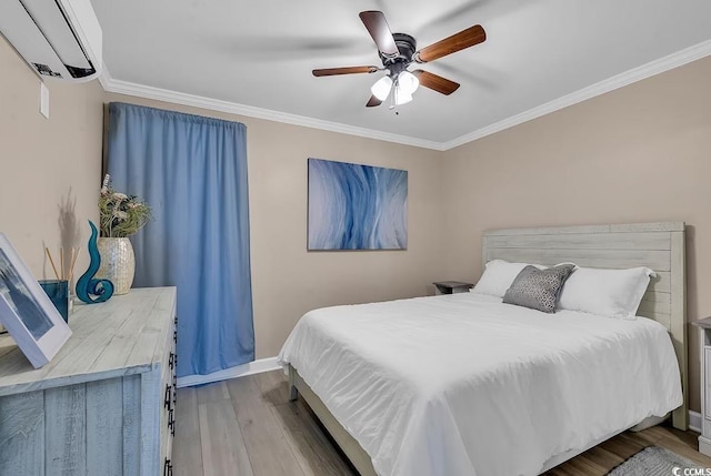 bedroom with ceiling fan, light hardwood / wood-style floors, ornamental molding, and a wall mounted AC