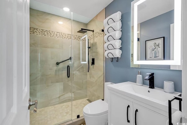 bathroom with a shower with door, vanity, and toilet