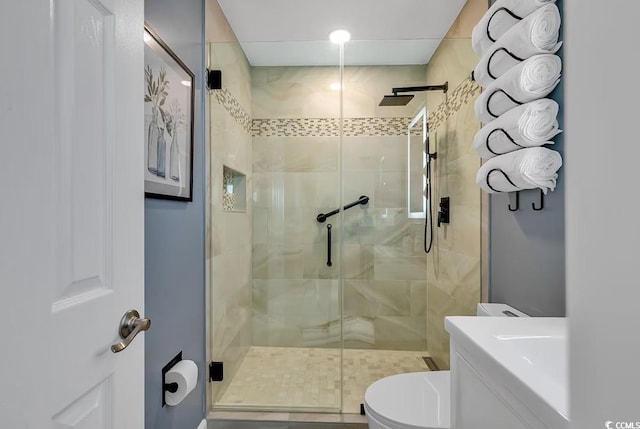 bathroom with vanity, toilet, and walk in shower