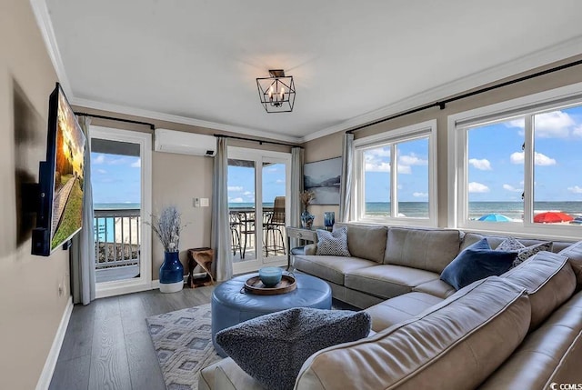 living room with dark hardwood / wood-style flooring, ornamental molding, a water view, an AC wall unit, and a notable chandelier