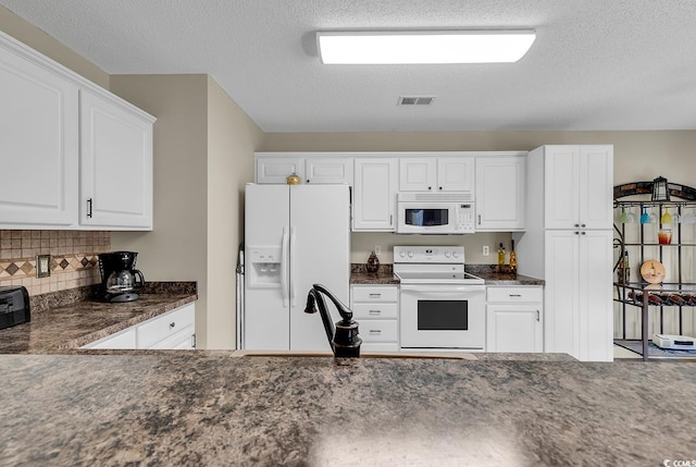 kitchen with white cabinets, backsplash, white appliances, and a textured ceiling