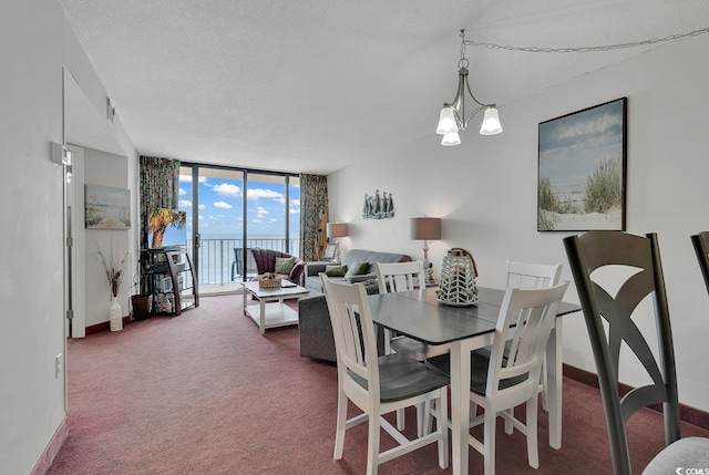 dining room featuring floor to ceiling windows, carpet floors, a textured ceiling, and an inviting chandelier