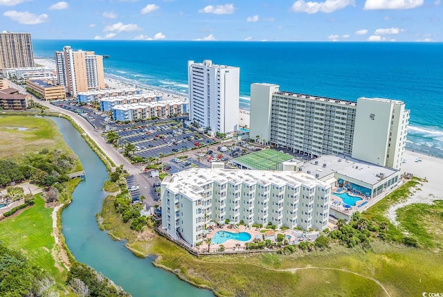 birds eye view of property with a water view and a beach view