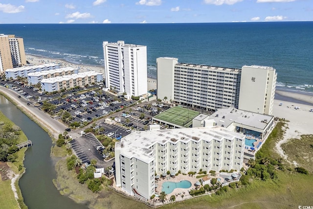 drone / aerial view featuring a water view and a beach view