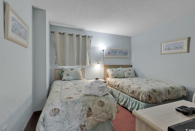 bedroom with a textured ceiling and carpet floors