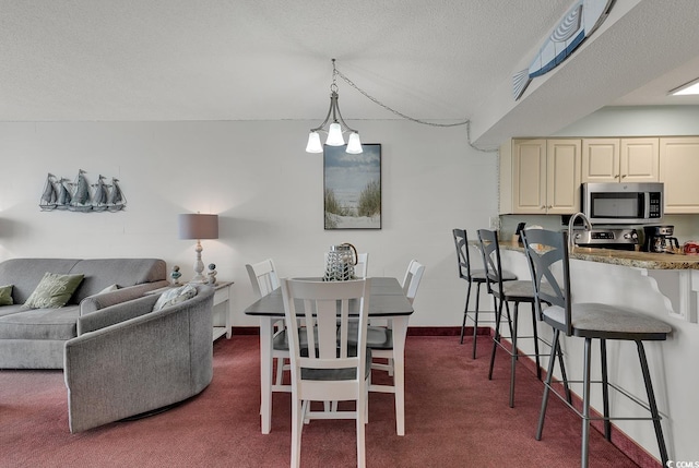 carpeted dining space with a textured ceiling and an inviting chandelier