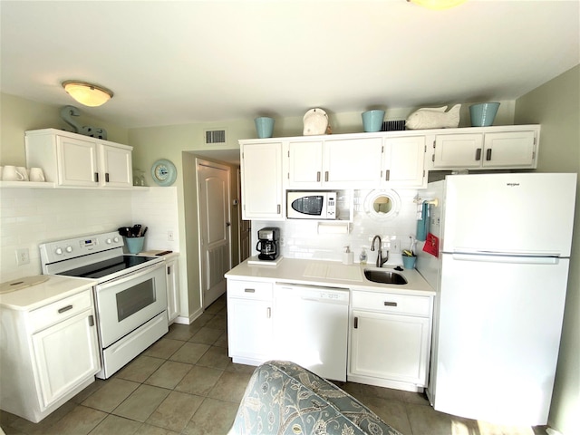 kitchen featuring white cabinets, white appliances, tasteful backsplash, and sink