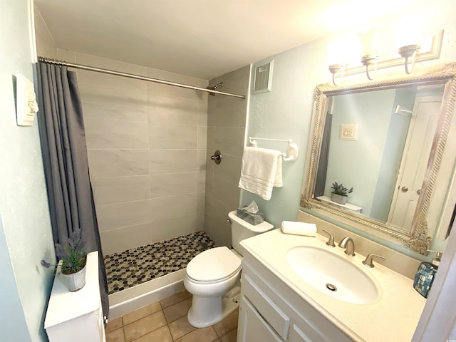 bathroom with a shower with shower curtain, vanity, tile patterned flooring, and toilet