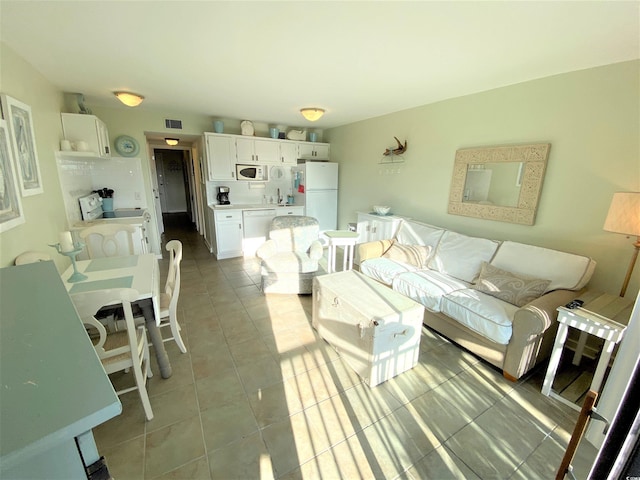 tiled living room featuring sink