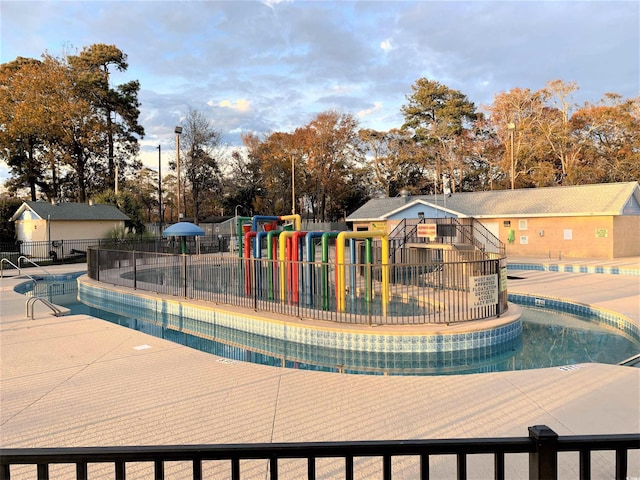 view of pool with a playground