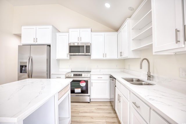 kitchen with appliances with stainless steel finishes, white cabinets, a sink, and open shelves