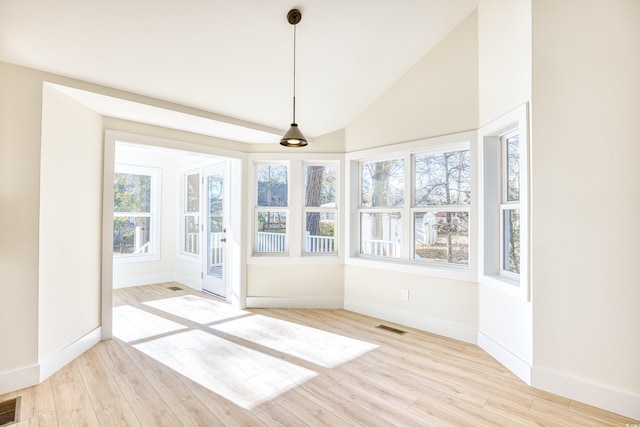 unfurnished sunroom featuring lofted ceiling and visible vents