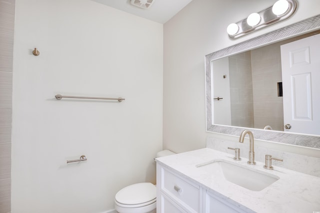 bathroom with visible vents, vanity, and toilet