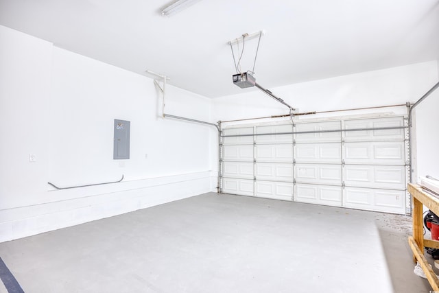 garage with electric panel and a garage door opener