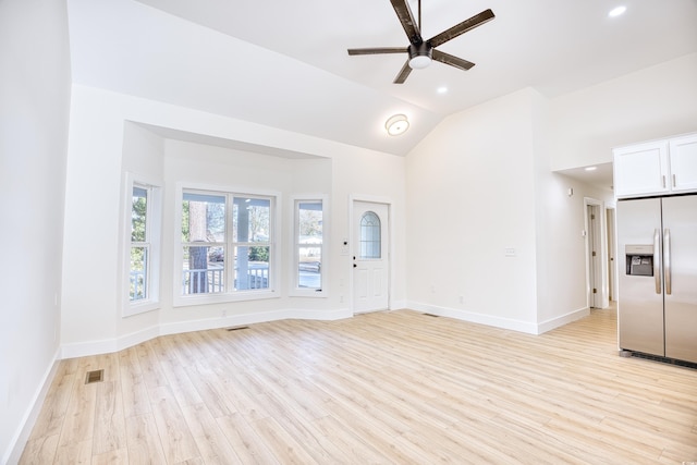 unfurnished living room featuring baseboards, visible vents, a ceiling fan, lofted ceiling, and light wood-style floors