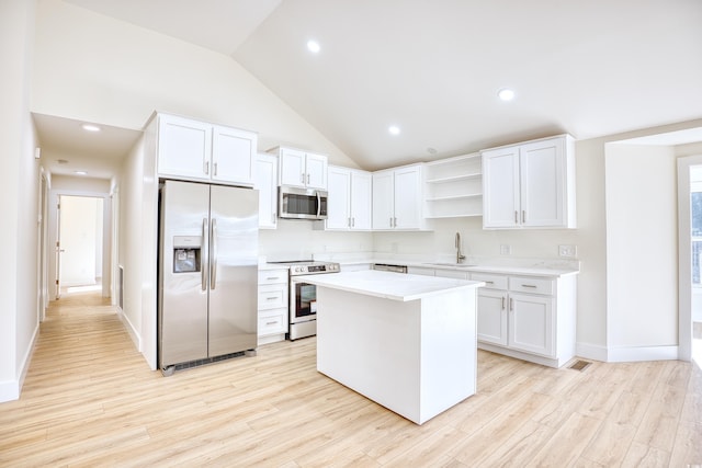 kitchen with open shelves, stainless steel appliances, light countertops, white cabinets, and a sink