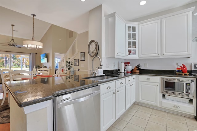 kitchen with white cabinets, kitchen peninsula, and appliances with stainless steel finishes