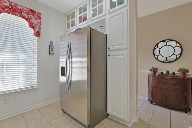 kitchen with white cabinetry, stainless steel fridge with ice dispenser, and light tile patterned flooring