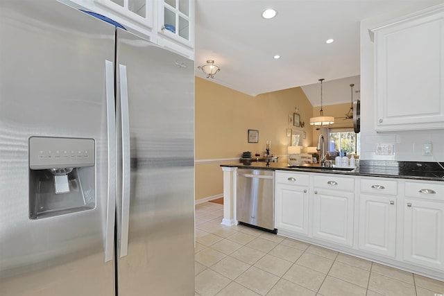 kitchen with white cabinets, light tile patterned floors, stainless steel appliances, and sink