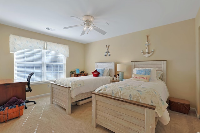 bedroom with ceiling fan and light carpet