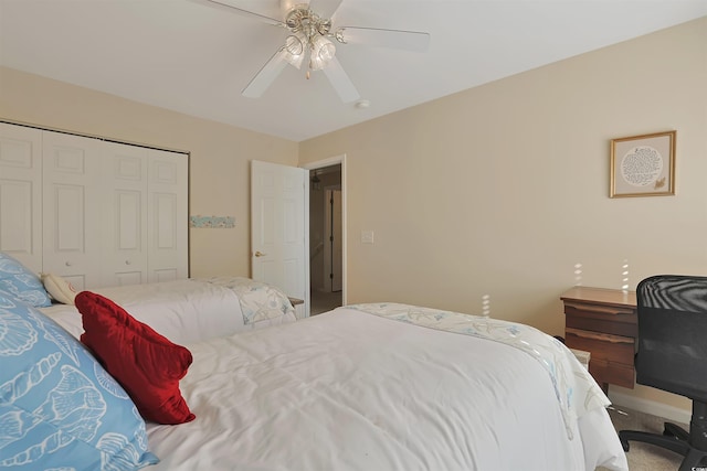 carpeted bedroom featuring ceiling fan and a closet