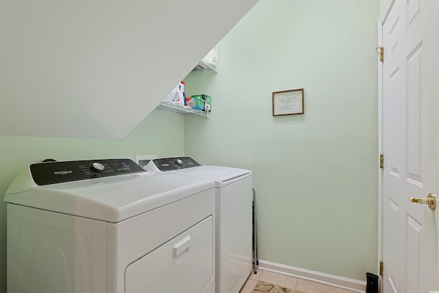 washroom with independent washer and dryer and light tile patterned flooring