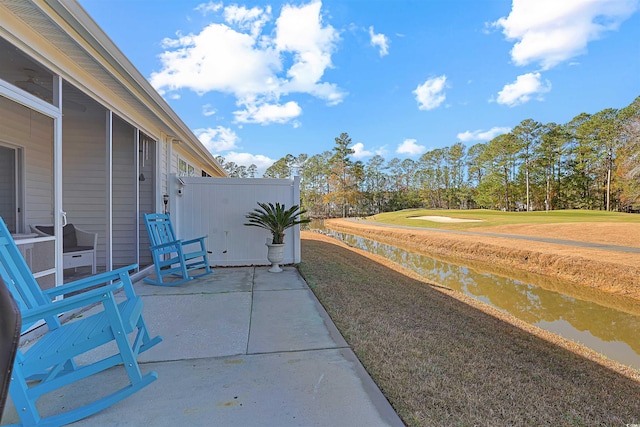 view of yard with a water view and a patio