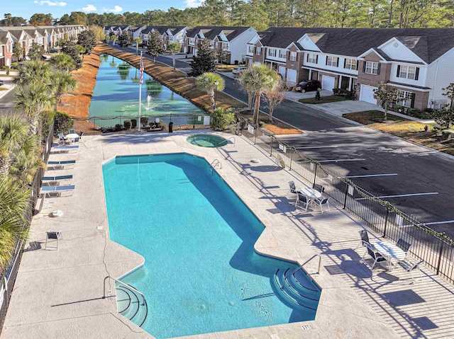 view of swimming pool with a community hot tub and a patio