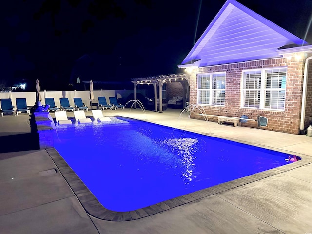 pool at twilight with a pergola, pool water feature, and a patio area