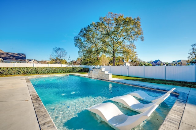 view of pool featuring pool water feature and a patio