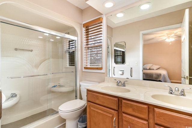 bathroom with vanity, toilet, and a shower with shower door