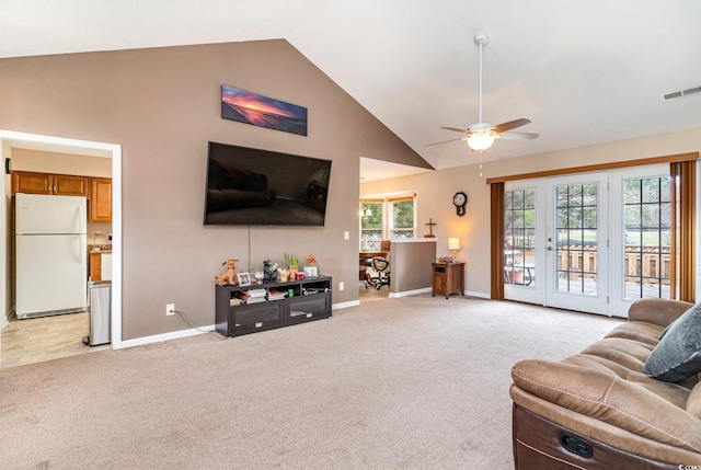 living room featuring ceiling fan, light colored carpet, and vaulted ceiling