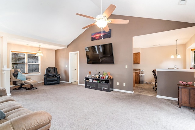 living room featuring vaulted ceiling, carpet floors, and ceiling fan with notable chandelier