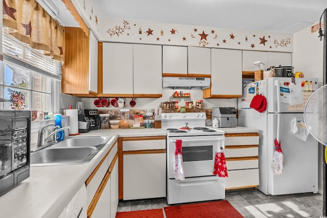 kitchen with white cabinets, white appliances, and sink