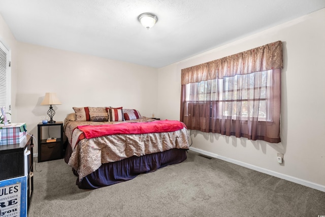 carpeted bedroom with a textured ceiling