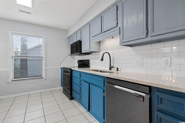 kitchen featuring blue cabinets, a sink, visible vents, black appliances, and tasteful backsplash