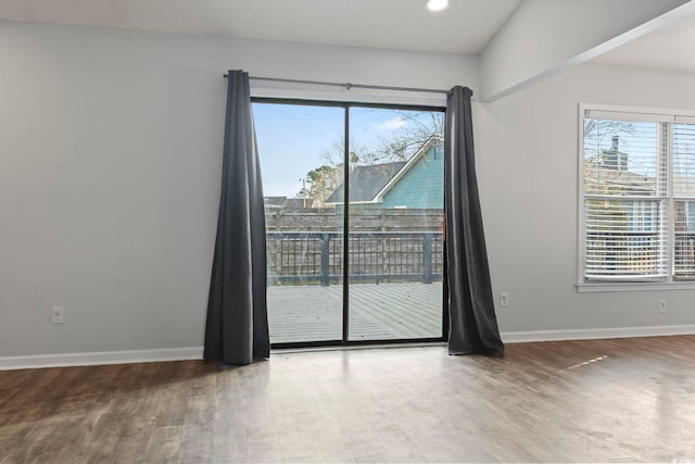 empty room featuring baseboards and wood finished floors