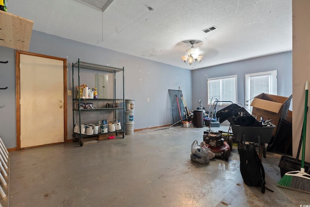 garage with baseboards, visible vents, and ceiling fan