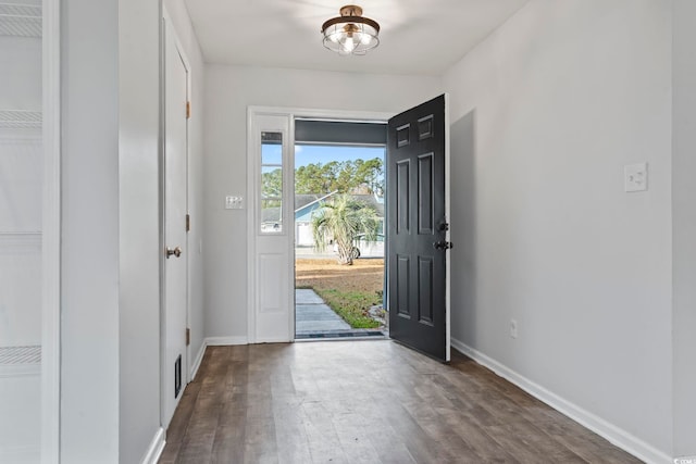 entryway featuring baseboards and wood finished floors