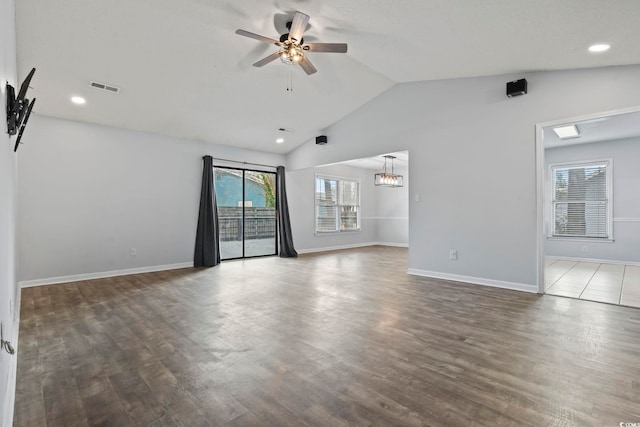 unfurnished room featuring baseboards, visible vents, a ceiling fan, wood finished floors, and vaulted ceiling