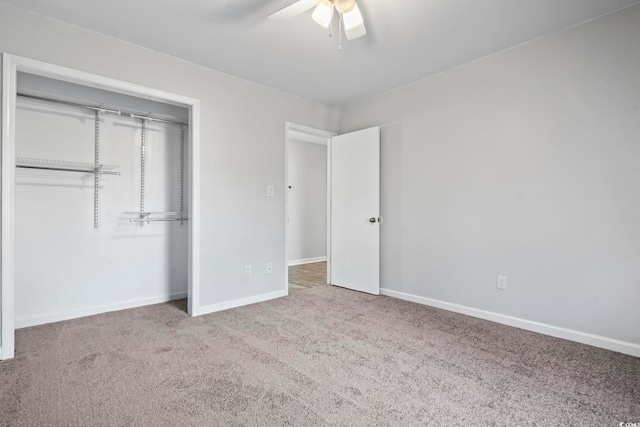 unfurnished bedroom featuring carpet, a closet, ceiling fan, and baseboards