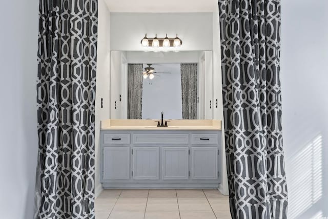 bathroom with curtained shower, tile patterned flooring, vanity, and a ceiling fan