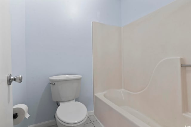 bathroom featuring tile patterned flooring, baseboards, and toilet