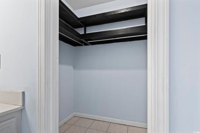 walk in closet featuring light tile patterned flooring