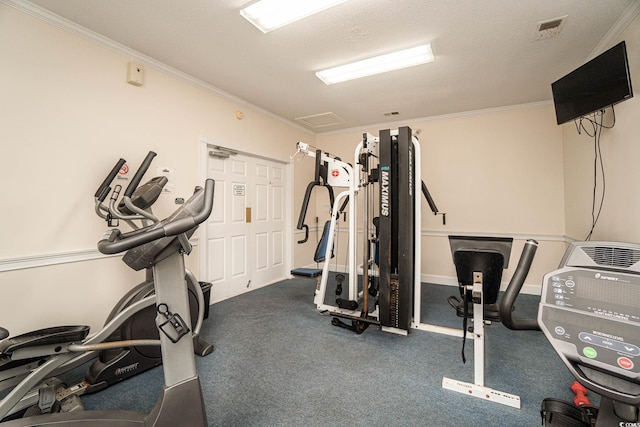 exercise area featuring a textured ceiling and ornamental molding