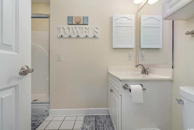 bathroom with a shower, vanity, tile patterned floors, and toilet