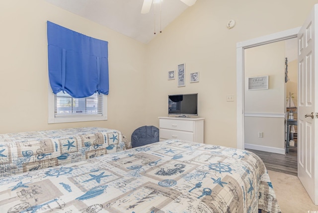 carpeted bedroom with ceiling fan and lofted ceiling