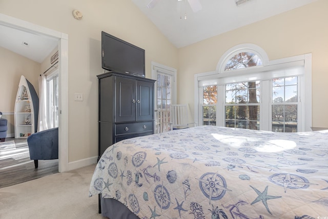 carpeted bedroom with ceiling fan and lofted ceiling