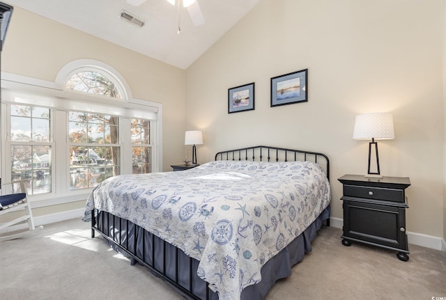 bedroom featuring ceiling fan, high vaulted ceiling, and light carpet